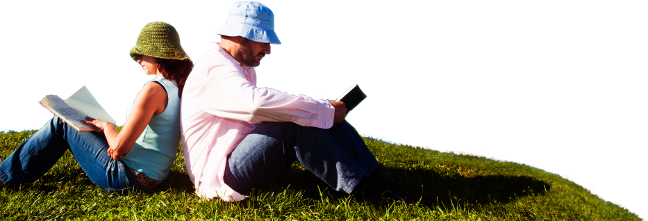 a man and a woman sitting on the grass reading books
